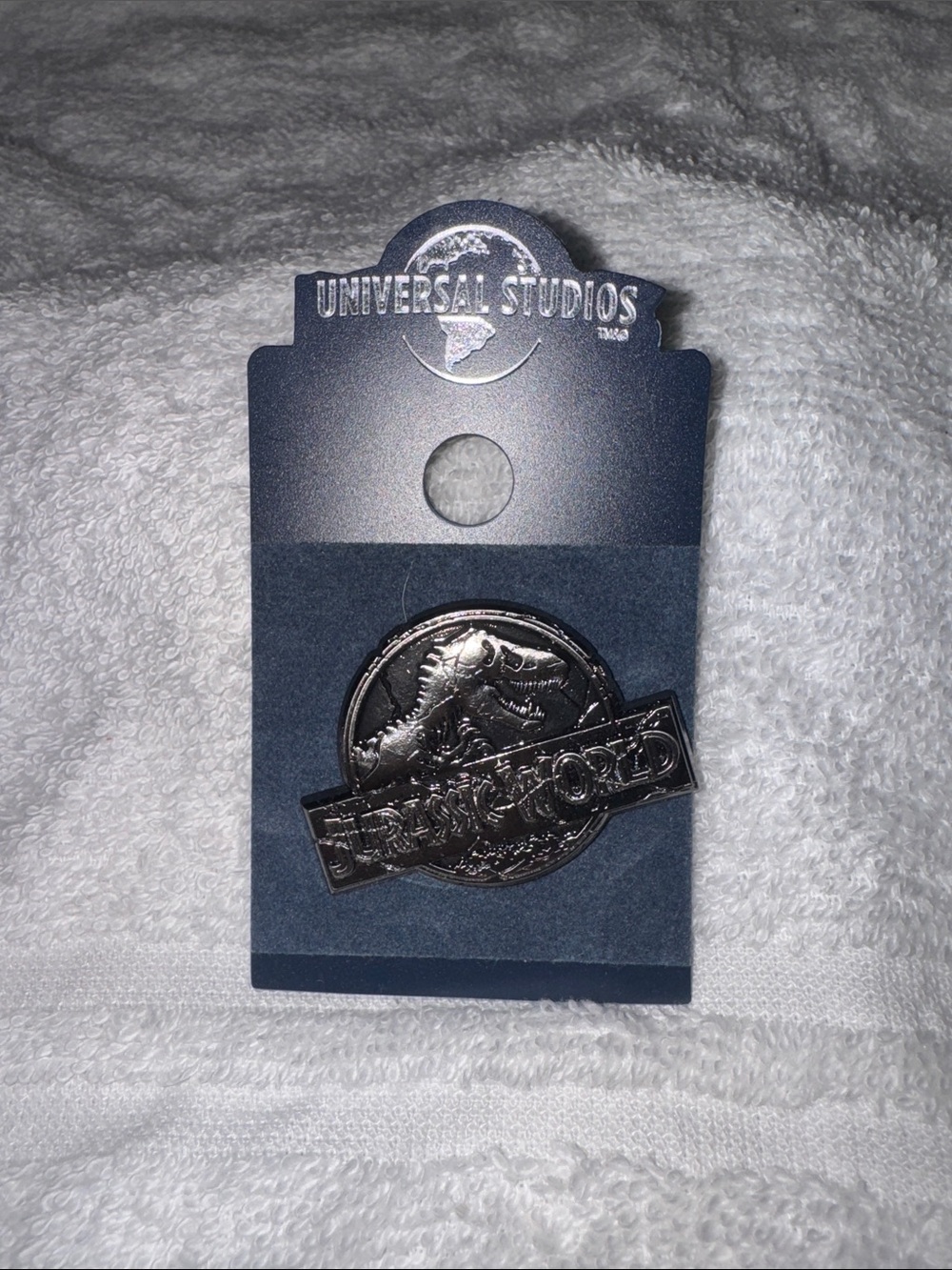 Universal Silver Jurassic World trading pin- Embossed Logo NEW
